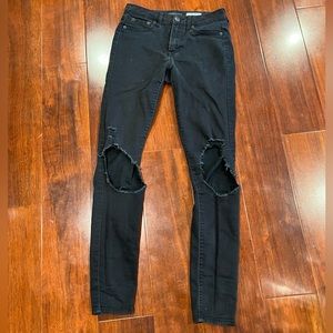 black skinny ripped jeans with rips on the knees